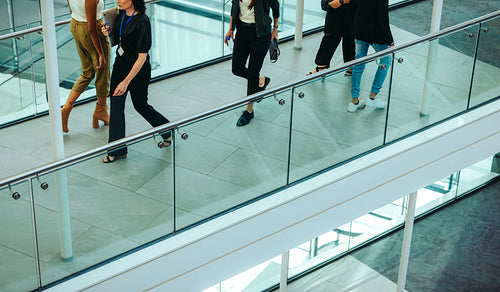 Corporate professionals walking in modern office building