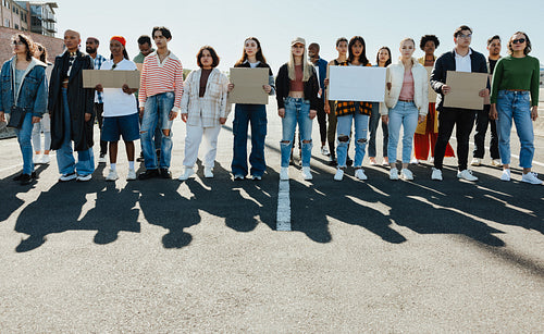 Large group of diverse demonstrators marching in solidarity for change in the world