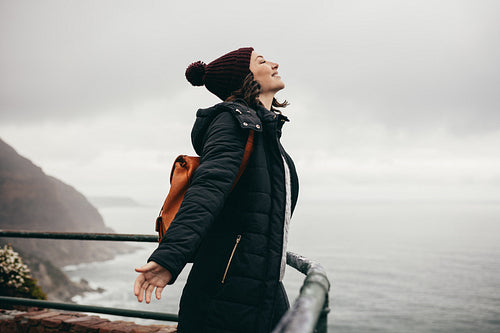 Woman enjoying the climate on mountain top