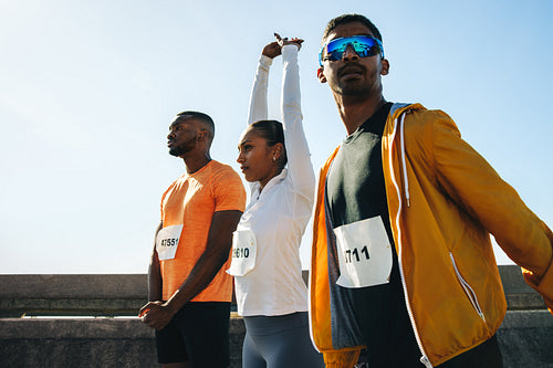 Athletes preparing for a race with stretching exercises