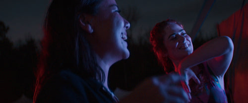 Vibrant friends dancing at a music festival