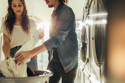 Couple looking at the clothes after wash