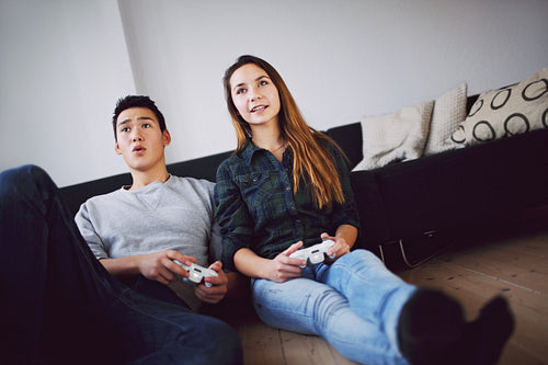 Young couple playing video games - Indoors