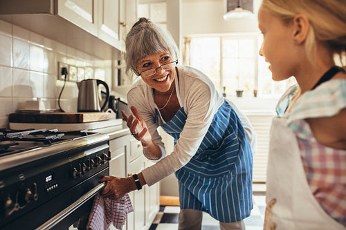 Granny and kid cooking in kitchen