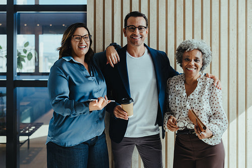 Mature team portrait highlighting collaboration in modern office