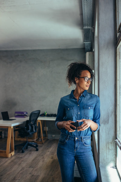 Woman entrepreneur looking out the window and thinking