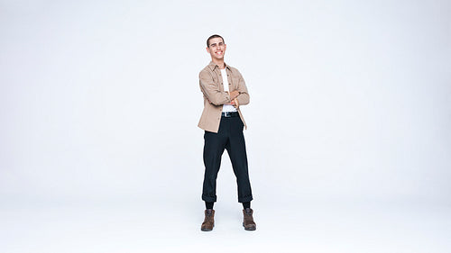 Young man standing against white background