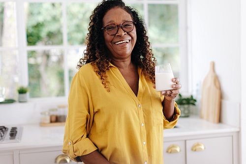 Portrait of a senior woman drinking a glass of fresh milk