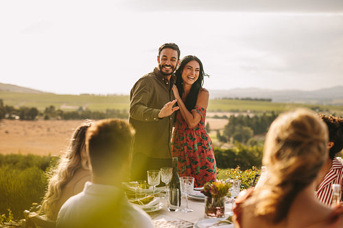 Couple at a party announcing their marriage to their friends