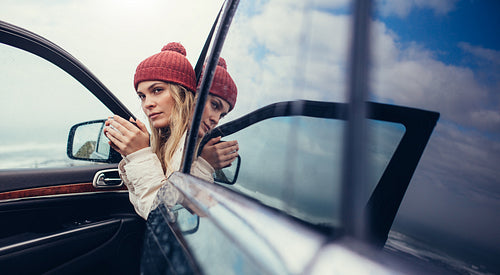 Woman taking coffee during road trip