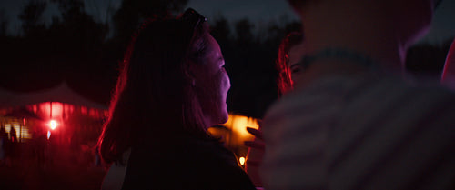 Young friends smiling and enjoying the festival nightlife together