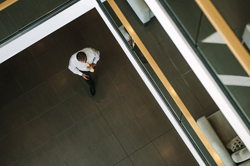 Businessman walking through office lobby