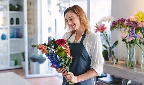 Florist creating bouquet at her shop
