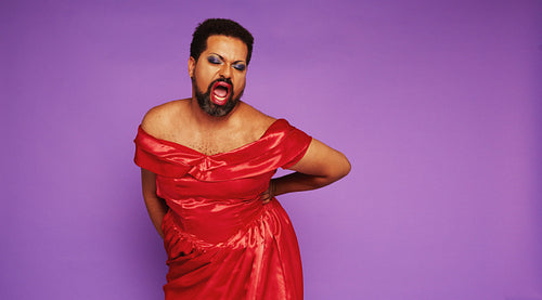 Male in drag singing in theater