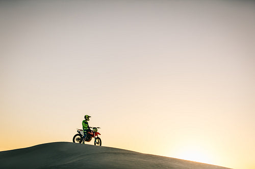 Motocross biker sitting on his bike
