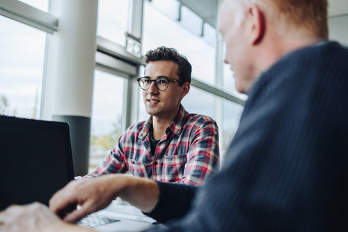 Young professional sharing his views in team meeting