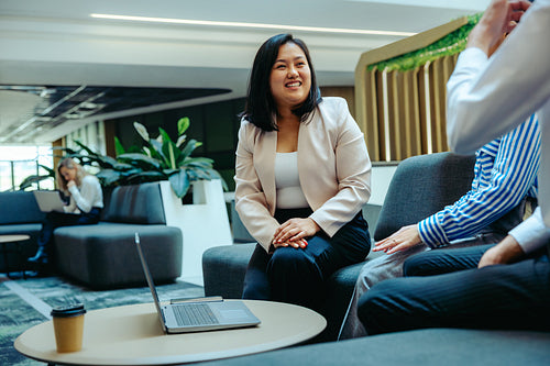 Professional woman engaged in a business meeting in a modern office lounge