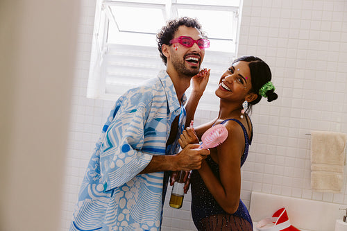 Brazilian carnival friends dancing in a bright bathroom