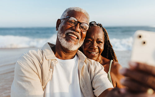 Senior African American couple taking a selfie on the beach