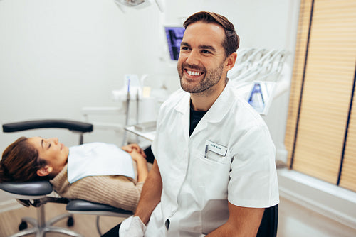 Dentist in dental office with patient for treatment