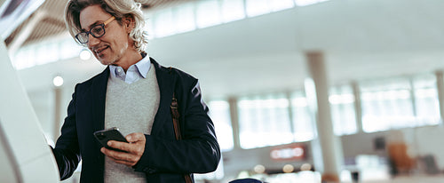 Businessman at airport making self check in