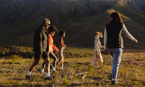 Group hiking together through mountain landscape