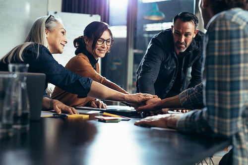 Business people making pile of hands