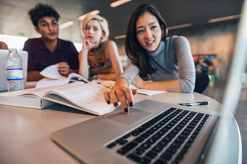 University students using laptop in a library