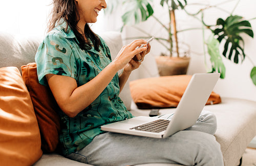 Young freelancer browsing her smartphone