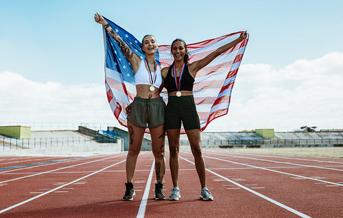 Runners celebrating on track with american flag