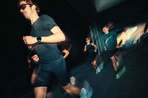 Group running with a run club during night training outdoors