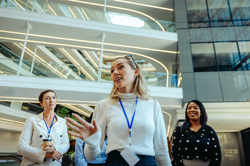 Female accountant showing new employees around modern office