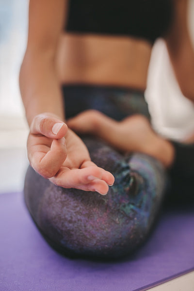 Woman hand sitting in lotus pose 