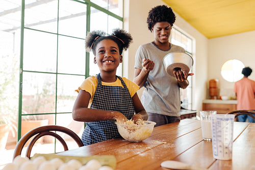 Black Brazilian family preparing the ingredients for a homemade cake