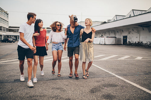 Young friends walking together on the street