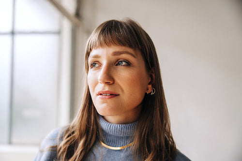 Pensive businesswoman looking away while standing in an office