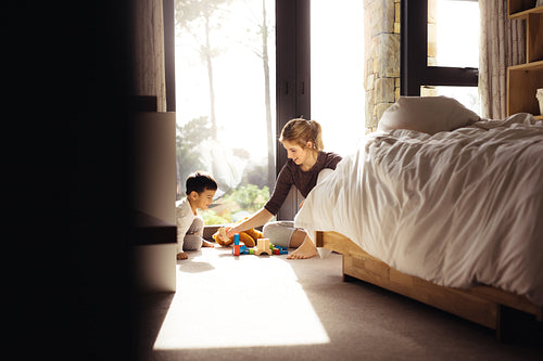 Mother and son playing with wooden blocks