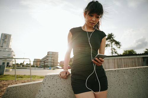 Caucasian woman having a break after running outdoors