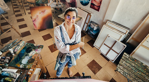 Happy female artist smiling in her art studio