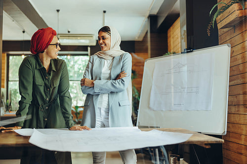 Cheerful female designers having a discussion in an office