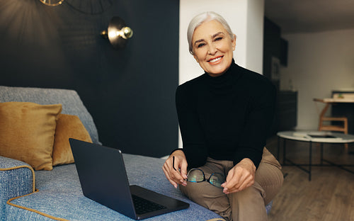 Mature business woman working from the comfort of her home
