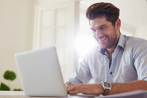 Happy businessman working from home office