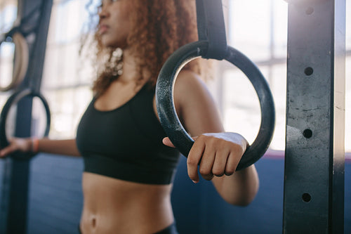 Woman exercising on gymnastic rings