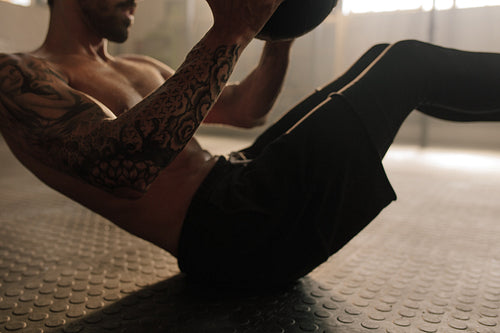 Man doing workout using medicine ball