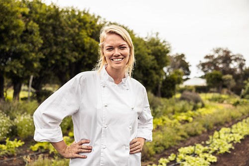 Young female chef smiling cheerfully on an organic farm
