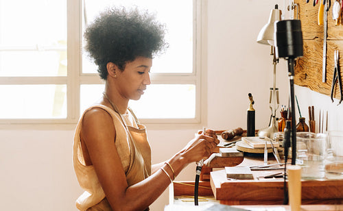 Woman artist designing ornaments using tools