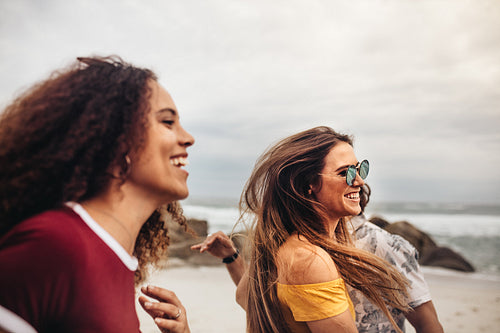 Beautiful woman with friends having fun on the beach