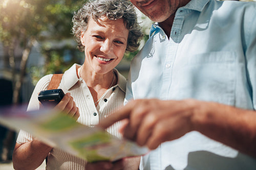 Middle aged couple looking at city map