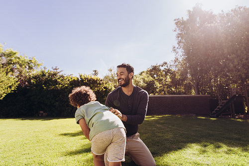 Man playing with his son in the park