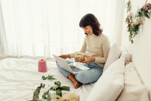 Woman showing christmas presents on video call